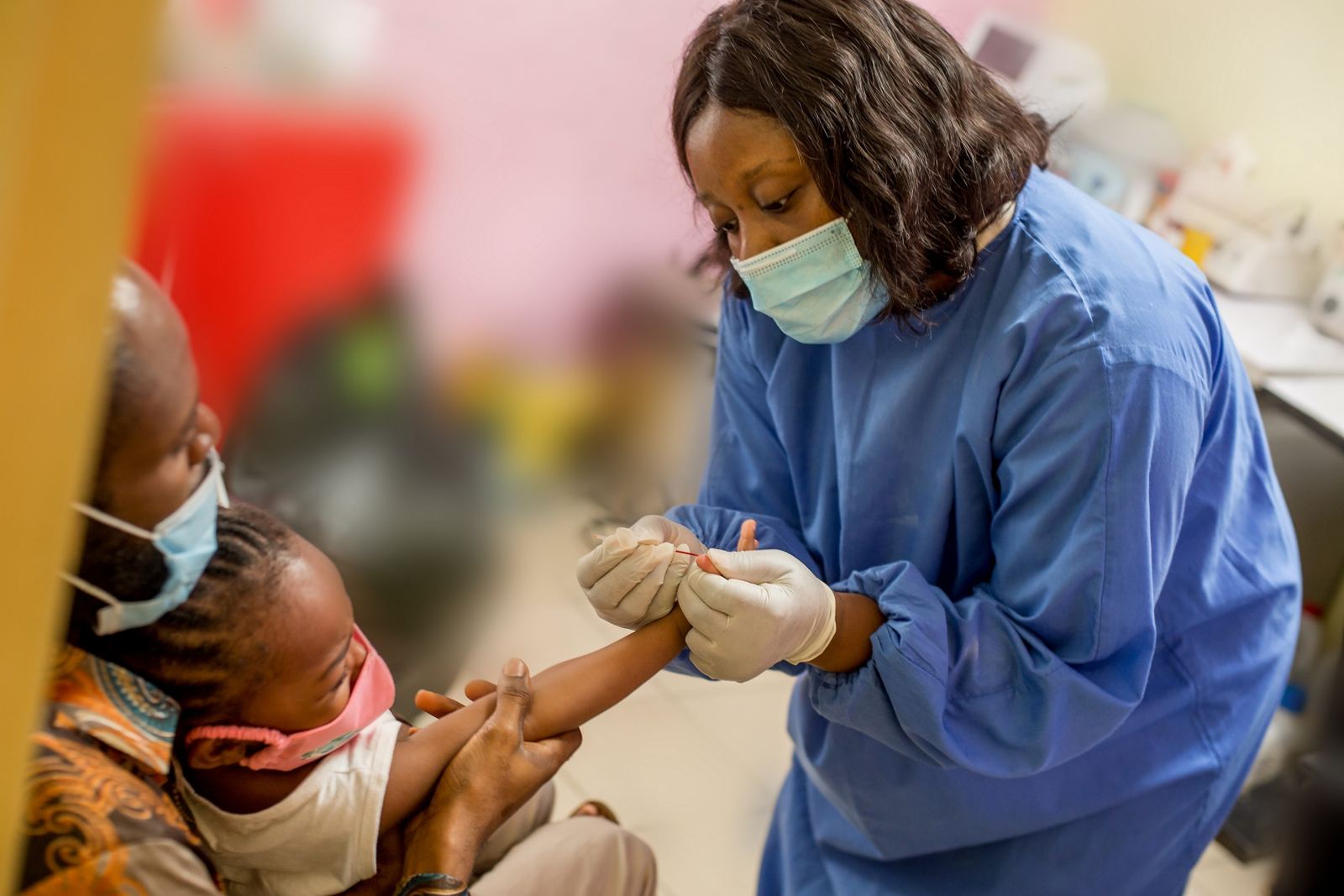 A clinician gently reassuring a young child