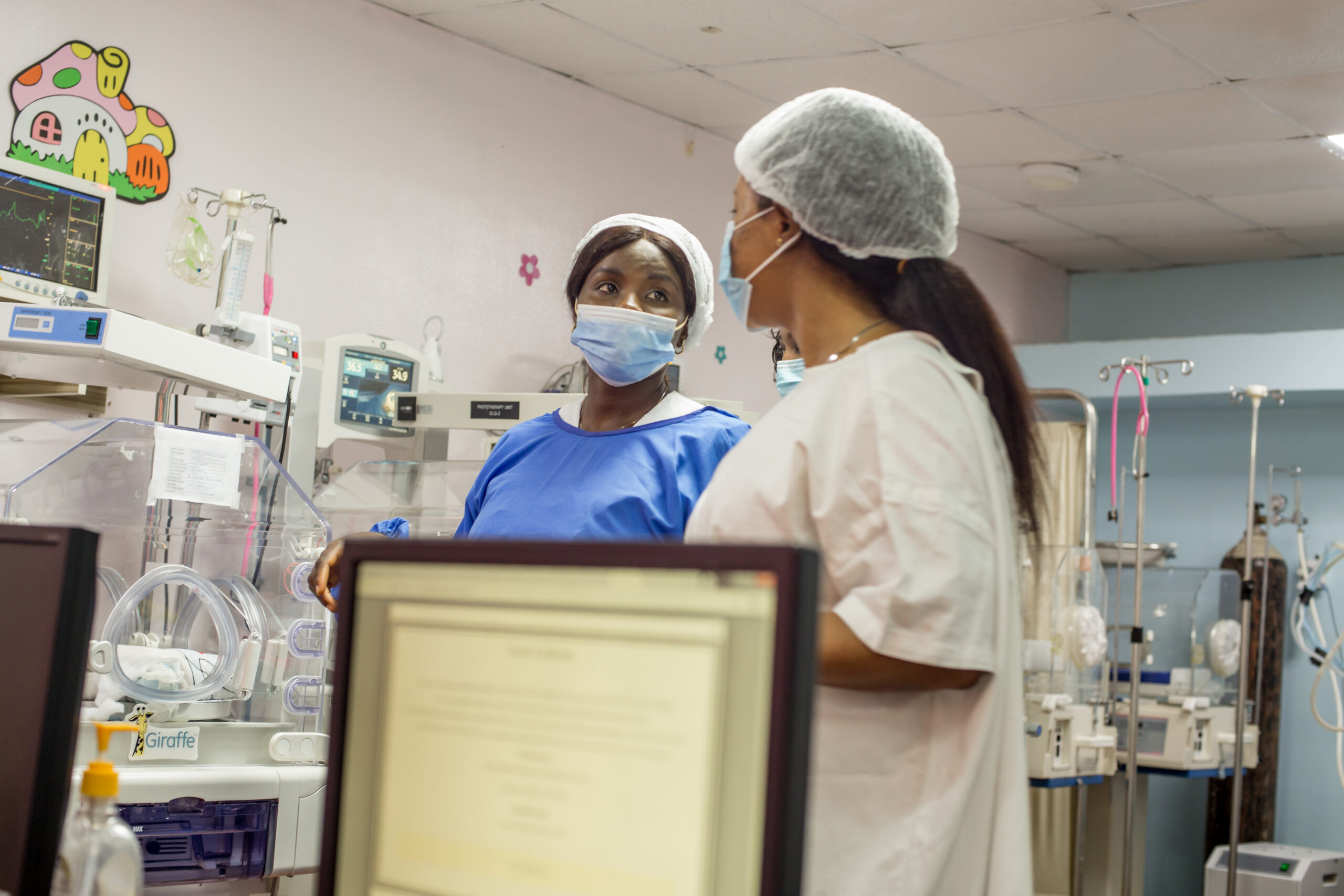Limi neonatal professionals reviewing care in the NICU