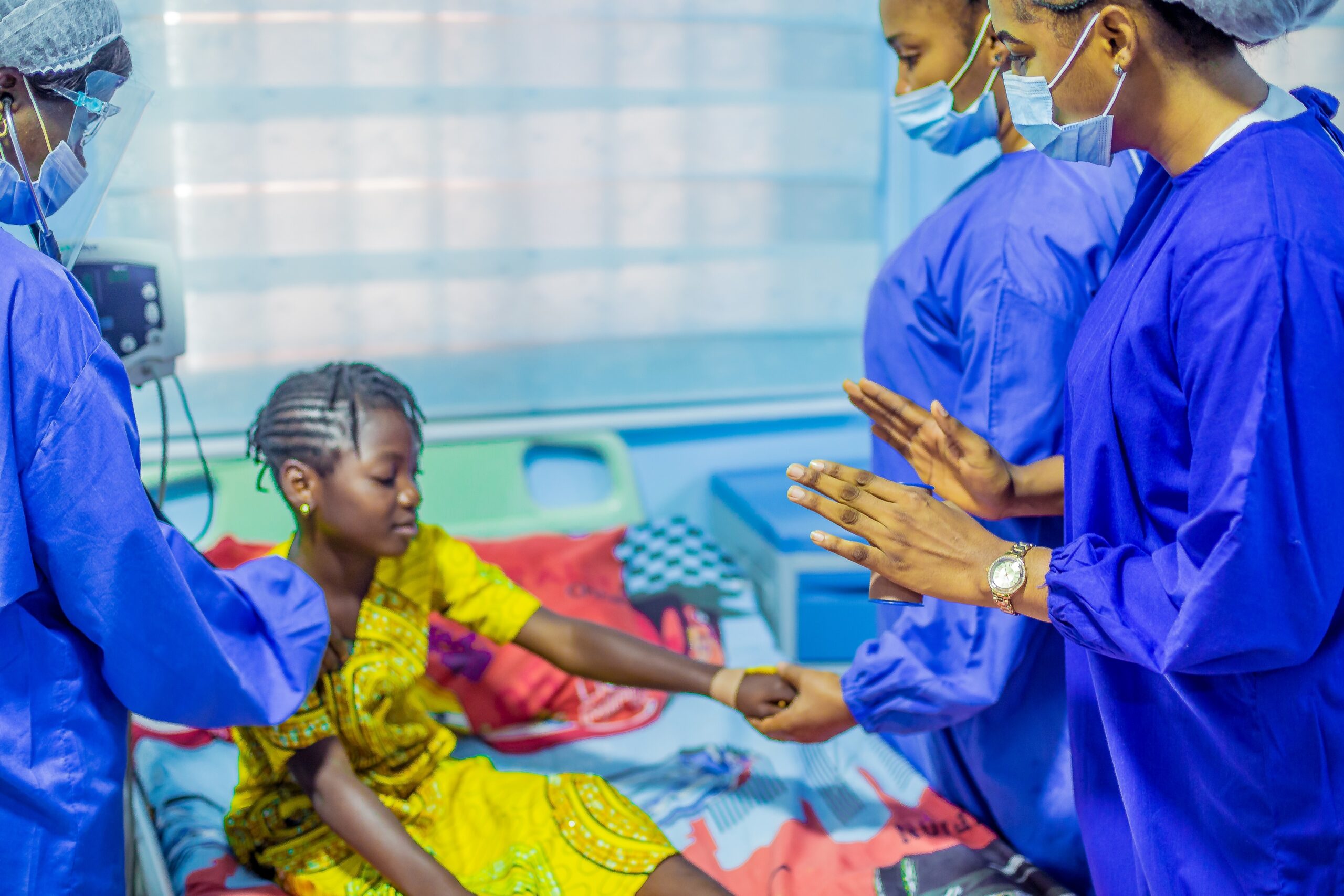 Limi clinicians supporting a child during a bedside assessment